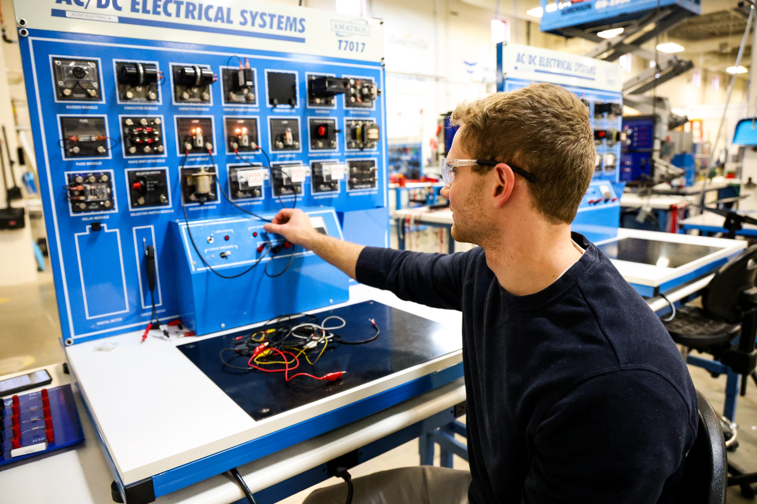 Student in OTECH's Automation Technology program working with electrical systems training panel in the Automation Technology lab at Ogden-Weber Technical College.